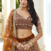 Close-up shot of the blouse part of the Brown Sangeet Lehenga Choli, highlighting its intricate t...