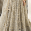 Back view of ivory net lehenga choli with sequence work showcases its fluid silhouette and ornate...