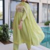 Pista green chanderi anarkali pant suit styled with traditional jewelry and shoes.
