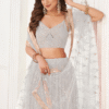Stylishly posed model wearing the White Thread Embroidery Party Lehenga Choli with a matching dup...