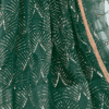 Magnified view of mirror work embroidery on green fabric